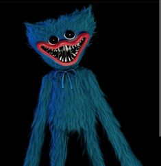 a blue stuffed animal with big teeth and red eyes on a black background that appears to be creepy