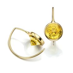 two pairs of earrings with yellow stones on them