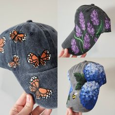 three hats with butterflies painted on them, one in grey and the other in blue