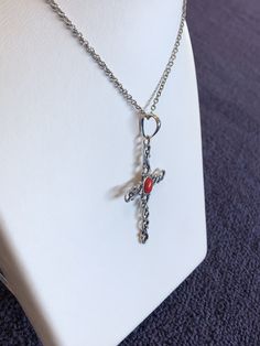 "This cross displays a beautiful piece of Red Coral in the middle of a wavy cross. The cross is about 2.5\" and 1.5\" in width. The chain is 18\" Please let us know if you have any questions!" Metal Cross Necklace With Adjustable Chain, Metal Crucifix Cross Necklace As Gift, Metal Crucifix Cross Necklace Gift, Metal Crucifix Cross Necklace For Gift, Adjustable Chain Metal Cross Necklace, Red Cross Pendant Necklace Gift, Red Cross Pendant Necklace For Gift, Red Crucifix Cross Necklace Gift, Red Crucifix Cross Necklace For Gift