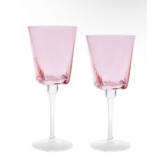 two pink wine glasses sitting next to each other