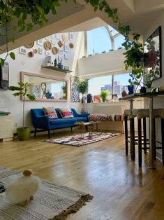 a living room filled with furniture and lots of windows