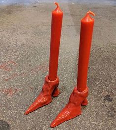 two red candles that are sitting on the ground