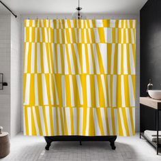 a bathroom with a yellow shower curtain and white tile flooring in front of it