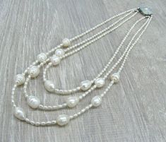 "Triple pearl necklace, layering multi strand necklaces, Mother's day gift, gift for bride, wedding pearl jewelry, white rice pearls, freshwater pearls. Length: 17.5\" or 44 cm by shorter strand. Please see photos on the model. Small rice shaped freshwater pearls measure 3X4 mm, they are white color with cream overtone, lustrous. You can see they are made by nature, because every bead has its own individuality, no 2 beads look alike. I used larger rice shaped freshwater pearl beads for the centr Multi-strand Pearl Beaded Necklace For Wedding, Wedding Multi-strand Pearl Beaded Necklace, Multi-strand Beaded Necklace With Pearl Drop For Wedding, Multi-strand Pearl Drop Beaded Necklaces For Weddings, Wedding Multi-strand Beaded Necklaces With Pearl Drop, Multi-strand Beaded Necklaces With Pearl Drop For Weddings, Wedding Multi-strand Beaded Necklace With Pearl Drop, Wedding Multi-strand Pearl Necklace With Pearl Drop, Wedding Pearl Necklace With Multi-strand Pearl Chain