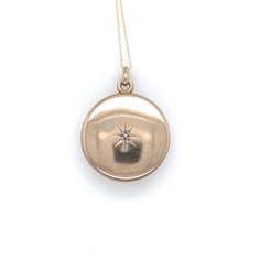 All of our jewelry is guaranteed authentic by our Graduate Gemologist of the Gemological Institute of America (GIA). 10k Yellow Gold Round Locket with Genuine Natural Diamond in Starburst (#J6433) 10k rosey yellow gold round locket on chain. The locket measures just over 1" long with bail by 3/4" diameter locket. There is a tiny diamond accent measuring about 1.5mm set in an engraved starburst. The pendant includes a new 18" 14k yellow gold chain. The necklace weighs 2.48 dwt., and the locket da Classic Round Yellow Gold Locket Necklace, Vintage 14k Gold Round Pendant Locket Necklace, Collectible Yellow Gold Round Pendant Locket Necklace, Gold Tarnish-resistant Round Locket Necklace, Antique Gold Round Locket Necklace, Hallmarked, Round Locket, Tiny Diamond, Big Bend, Yellow Gold Chain