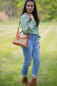 Our Maya rattan and leather trim handbag is a classic fun way to complete any look this season. Our handbags are all handmade. Want to add a little something special to your handbag? Accessorize with our 100% silk scarves. Ready to Ship! Please allow 1-2 business days to process your order and ship. Details: Rattan Leather trim Handmade Made in Indonesia Natural Rattan Shoulder Bag With Woven Leather, Brown Rattan Straw Bag With Woven Leather Details, Straw Shoulder Bag With Gold-tone Hardware, Basket-shaped Rattan Shoulder Bag With Woven Leather, Leopard Print Leather Bag With Gold-tone Hardware, Silk Scarves, Leather Trim, Something Special, Leather Trims