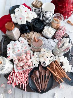 a platter filled with lots of different types of treats and candy canes on top of a table