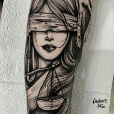 a woman's arm with a ship tattoo on it