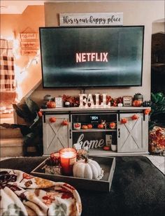 a living room filled with furniture and a flat screen tv on top of a wall