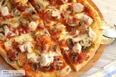 a pizza sitting on top of a wooden cutting board