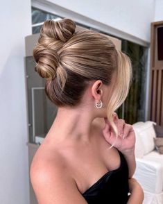 a woman with her hair in a low bun