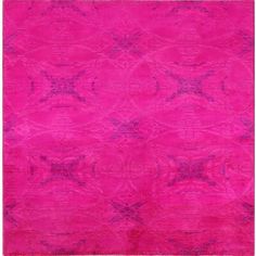 a bright pink rug with an intricate design on the top and bottom corner, in front of a white background