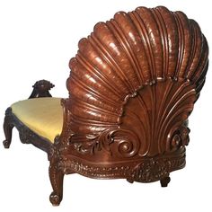 a chair with a shell shaped back and foot rest