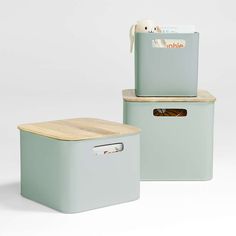 two storage containers with lids and handles on top of each other, one has a wooden lid