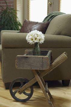 a living room scene with focus on the coffee table and flower arrangement in the center