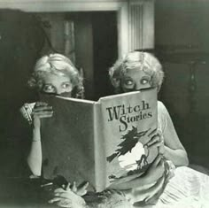 two children are reading a book together