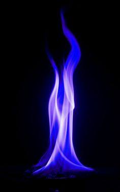 a blue flame is shown in the dark