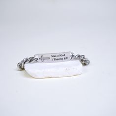 This solid stainless steel men's bracelet is made of high-quality and very durable surgical-grade stainless steel with a polish finish. Along with a polished silver cross. It will remind you of who you are in Christ. DETAILS: Metal: Stainless Steel Color: Silver Finish: Polished Engraving: "Man of God fight the good fight of the faith. 1 Timothy 6:11" Modern Silver Stainless Steel Name Bracelet, Silver Stainless Steel Bracelets For Father's Day, Father's Day Silver Stainless Steel Bracelets, Personalized Silver Stainless Steel Chain Bracelet, Durable Silver Stainless Steel Chain Bracelet, Stainless Steel Chain Bracelet With Polished Finish As Gift, Adjustable Stainless Steel Chain Bracelet With Polished Finish, Adjustable Stainless Steel Chain Bracelet, Minimalist Silver Stainless Steel Name Bracelet