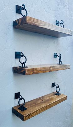 three wooden shelves with metal brackets on them