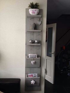 a wall shelf that has some items on top of it in front of a door