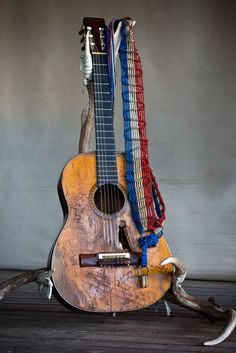 an old guitar is sitting on the floor