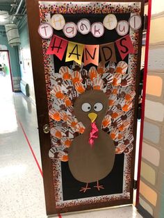 a door decorated to look like a turkey with handprints on it's face