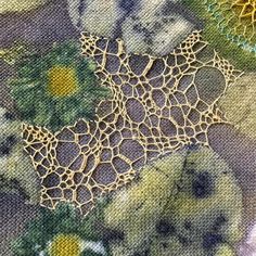 an intricate piece of fabric with flowers on it