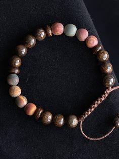 "This bracelet is made with natural polished Bronzite Jasper and matte Picasso Jasper in size 8mm.  Beautiful elegant yet minimalist design is perfect gift for self or your loved ones. Bronzite is used for protection, as it not only repels, but also sends back the negative energies to the sender. Spiritually, Bronzite assists us in achieving a state of certainty without wilfulness, allowing us to easily adapt to the best path to take. It clears confusion, helping our ability to make decisions an Adjustable Jasper Bracelets With Natural Stones, Adjustable Brown Jasper Bracelet, Hand-strung Jasper Beaded Bracelets As Gift, Jasper Beaded Bracelets With 8mm Beads As Gift, Adjustable Jasper Beaded Bracelets With 8mm Beads, Earthy Hand-strung Bracelets With Round Beads, Earthy Hand-strung Round Bead Bracelets, Earthy Hand-strung Bracelets, Adjustable Jasper Beaded Bracelets With Round Beads