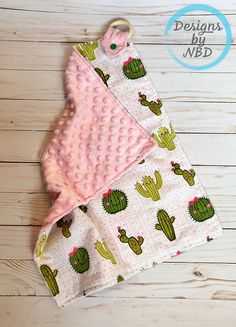 two baby blankets with cactus designs on them, one is pink and the other is green