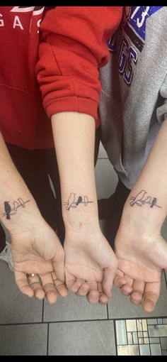 two people with matching tattoos on their arms