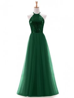 a green evening gown on a mannequin dummyt with sequins and beads