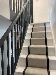 a staircase with carpeted steps leading up to the second floor