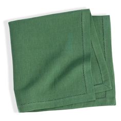 two folded green napkins sitting on top of each other