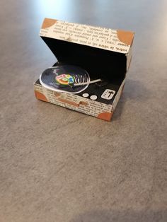 an open box with a plate inside on a table