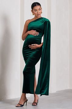 For a stunning maternity look that will always be remembered. take a look at our gracious Amaryllis gown. This green bodycon dress is made from a premium stretch velvet that's partially-lined for comfort and support. Finished with a sweeping cape sleeve and a split skirt. this asymmetric maxi dress deserves a place in your maternity wardrobe. Features - Premium stretch velvet- Asymmetric neckline- Single cape sleeve- Invisible zip closure - Bodycon fit - Bump ruching- Split hemline- Maxi length Dress With Cape, Midi Bridesmaid Dress, Green Bodycon Dress, Maternity Wardrobe, One Shoulder Maxi Dress, Pregnancy Looks, Pregnancy Wardrobe, Asymmetric Neckline, Party Dress Long Sleeve