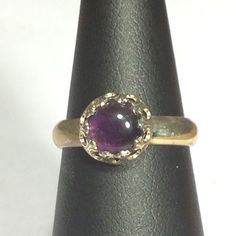 Sterling Silver Band with 8mm Amethyst stone in center. This ring is a size 6-3/4. (R12) Purple Cabochon Amethyst Wedding Ring, Amethyst Birthstone Ring With Round Stone, Round Cabochon Amethyst Ring, Classic Round Purple Crystal Ring, Classic Purple Crystal Round Ring, Classic Purple Round Crystal Ring, Round Amethyst Ring With Center Stone, Classic Purple Crystal Ring, Formal Round Band Amethyst Birthstone Ring