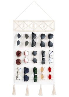 PRICES MAY VARY. Perfect Sunglasses Organizer: Our hanging glasses organizer has 15 pockets with 3.5"W x 4.75"H, is suitable for most sunglasses, eyeglass, eyewear storage. Transparent PVC pocket can not only storage but keep your sunglasses on display, you can easily find the one you want at any time. Functional & Decorative: 15 slots with clear cover, this hanging eyeglasses holder can safely store your sunglasses to prevent scratches, keep your glasses organized and clean. Also, you can use i Diy Sunglasses Holder, Eyewear Display, Sunglasses Organizer, Glasses Storage, Decorative Tassels, Sunglasses Storage, Tassels Decor, Closet Accessories, Door Hooks