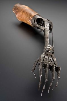 a metal object that looks like a hand holding a corkscrew with it's fingers