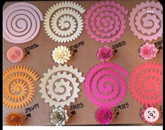 paper flowers are arranged on a board with the words happy birthday written in them and placed next to each other