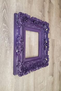 an ornate purple frame hanging on the wall