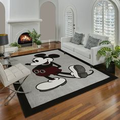 a living room with a mickey mouse rug on the floor