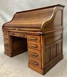 an old wooden desk with drawers on it