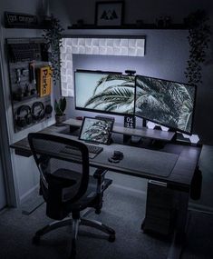 two computer monitors sitting on top of a desk in front of a window at night