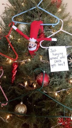 a christmas tree decorated with elf hats and ornaments