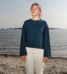 A Foundational Wardrobe Piece-Taking cues from Intention Tee, a favorite from seasons past, the Intent Tee is the long-sleeved sister silhouette. Crafted from dense knit cotton & dyed with plants, the easeful top is mindfully cut to have a loose, slightly oversized fit equally suited for lounging & layering. The shapely tee is characterized by a classic crew neckline with exposed stitching to create an illusionary V-dip along the neck, a subtle detail adding a touch of enchantment to the everyda Organic Cotton Tops For Fall Loungewear, Fall Organic Cotton Loungewear Tops, Organic Cotton Long Sleeve Tops For Loungewear, Fall Cotton Sweatshirt In Washed Blue, Washed Blue Cotton Long Sleeve Tops, Long Sleeve Washed Blue Cotton Tops, Fall Washed Blue Cotton Sweatshirt, Blue Organic Cotton Long Sleeve Tops, Relaxed Fit Long Sleeve Top With Natural Dye