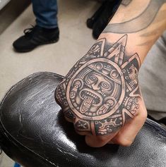 a person with a tattoo on their hand