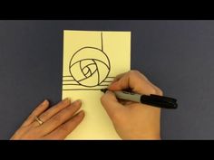 a person drawing on a piece of paper