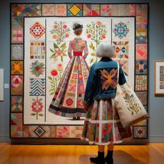 a woman looking at a quilt on display