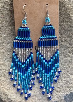 a pair of blue and silver beaded earrings